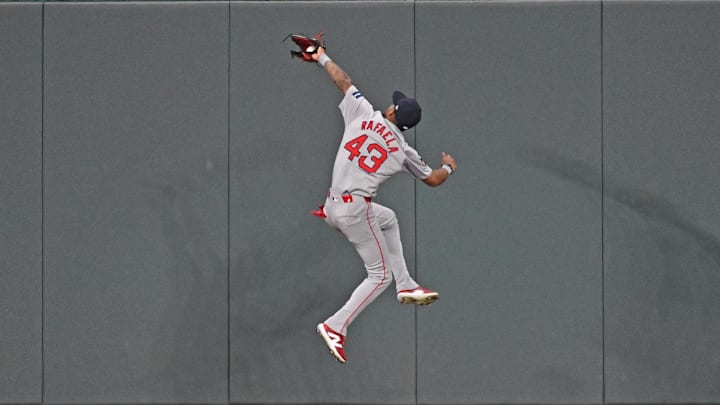 Aug 5, 2024; Kansas City, Missouri, USA;  Boston Red Sox center fielder Ceddanne Rafaela (43) catches a fly ball in front of the center field wall against Kansas City Royals Maikel Garcia (not pictured) in the fifth inning at Kauffman Stadium. Mandatory Credit: Peter Aiken-USA TODAY Sports