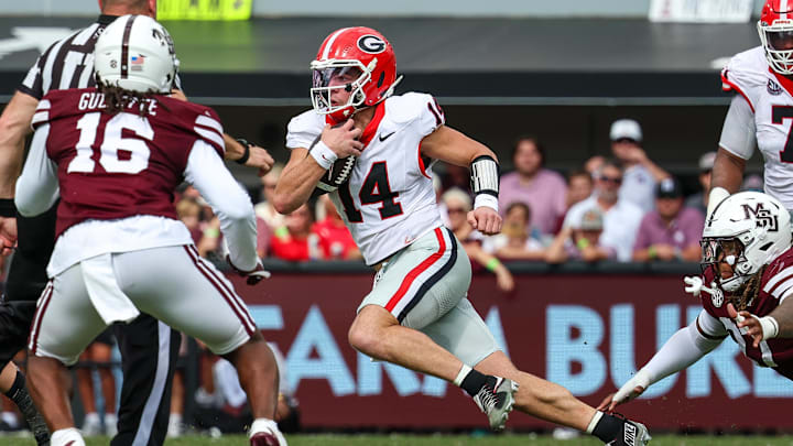 Nov 8, 2025; Starkville, Mississippi, USA; Georgia Bulldogs quarterback  Gunner Stockton (14) runs with the ball against the Mississippi State Bulldogs during the first half at Davis Wade Stadium at Scott Field. Mandatory Credit: Wesley Hale-Imagn Images