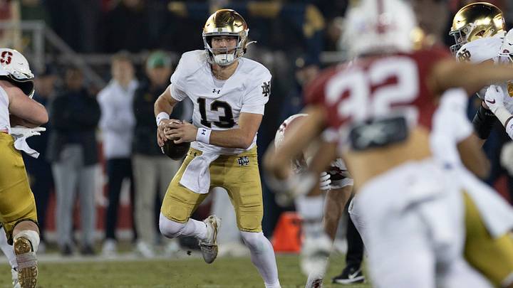 Nov 29, 2025; Stanford, California, USA;  Notre Dame Fighting Irish quarterback CJ Carr (13) runs with the football during the first quarter against the Stanford Cardinal at Stanford Stadium. Mandatory Credit: Stan Szeto-Imagn Images