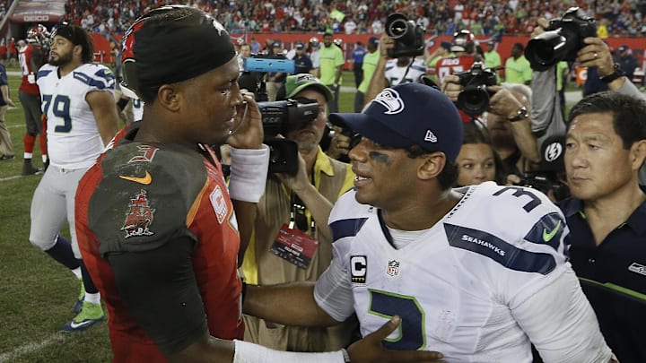 Quarterbacks Jameis Winston (left) and quarterback Russell Wilson (right) meet at midfield following an NFL football game at Raymond James Stadium. Quarterbacks Jameis Winston (left) and quarterback Russell Wilson (right) meet at midfield following an NFL football game at Raymond James Stadium.