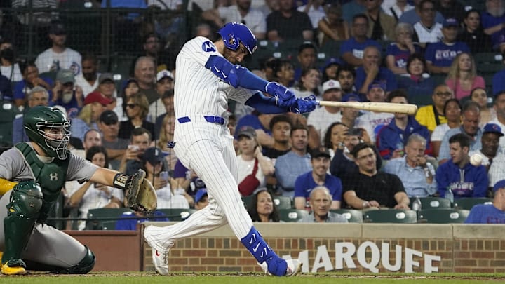 Sep 16, 2024; Chicago, Illinois, USA; Chicago Cubs outfielder Cody Bellinger (24) hits a single against the Oakland Athletics during the first inning at Wrigley Field.