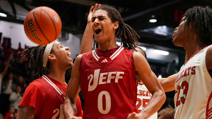 Jeffersonville Red Devils Tre Singleton (0) celebrates scoring against the Lawrence North 