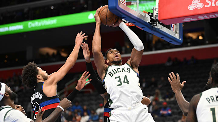 Dec 3, 2024; Detroit, Michigan, USA;  Milwaukee Bucks forward Giannis Antetokounmpo (34) grabs an offensive rebound away from Detroit Pistons guard Cade Cunningham (2) in the first quarter at Little Caesars Arena. Mandatory Credit: Lon Horwedel-Imagn Images