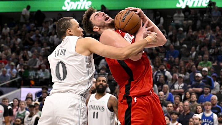 Feb 8, 2025; Dallas, Texas, USA; Houston Rockets center Alperen Sengun (28) reacts to being found by Dallas Mavericks guard Dante Exum (0) during the second half at the American Airlines Center. Mandatory Credit: Jerome Miron-Imagn Images
