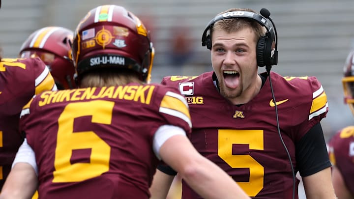 Drake Lindsey (5) celebrates with fellow Minnesota quarterback Max Shikenjanski