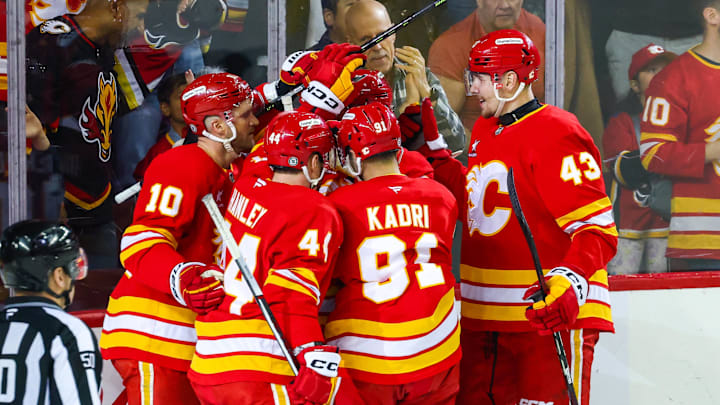 Apr 13, 2025; Calgary, Alberta, CAN; Calgary Flames defenseman MacKenzie Weegar (52) celebrates his goal with teammates against the San Jose Sharks during the first period at Scotiabank Saddledome. Mandatory Credit: Sergei Belski-Imagn Images