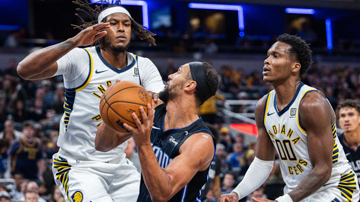 Nov 6, 2024; Indianapolis, Indiana, USA; Orlando Magic guard Jalen Suggs (4) shoots the ball while Indiana Pacers center Myles Turner (33) defends in the second half at Gainbridge Fieldhouse. Mandatory Credit: Trevor Ruszkowski-Imagn Images