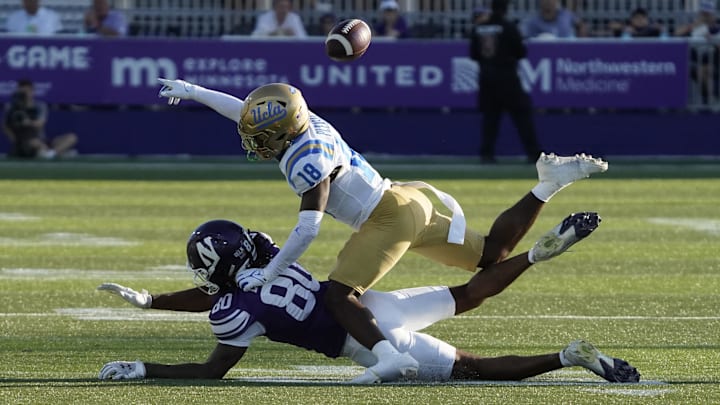 Sep 27, 2025; Evanston, Illinois, USA; UCLA Bruins defensive back Rodrick Pleasant (18) defends Northwestern Wildcats wide receiver Hayden Eligon II (80) during the second half at Northwestern Medicine Field at Martin Stadium. Mandatory Credit: David Banks-Imagn Images