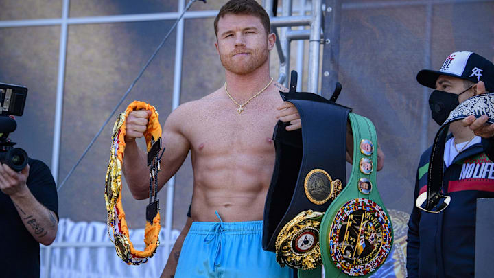 Boxer Canelo Alvarez poses for the fans with his title belts during weigh ins for his super middleweight boxing title fight against Billy Joe Saunders. Boxer Canelo Alvarez poses for the fans with his title belts during weigh ins for his super middleweight boxing title fight against Billy Joe Saunders.