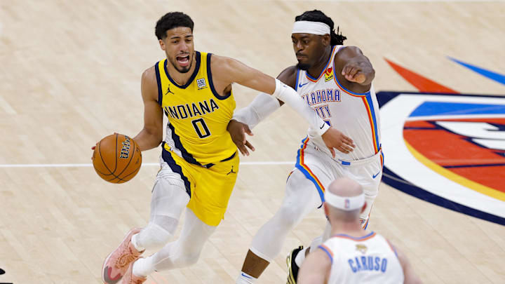Jun 16, 2025; Oklahoma City, Oklahoma, USA; Indiana Pacers guard Tyrese Haliburton (0) drives to the basket past Oklahoma City Thunder guard Luguentz Dort (5) during the third quarter in game five of the 2025 NBA Finals at Paycom Center. Mandatory Credit: Alonzo Adams-Imagn Images