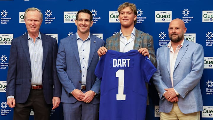 Apr 25, 2025; East Rutherford, NJ, US; New York Giants president John Mara (far left), general manager Joe Schoen (left), Jaxson Dart, and head coach Brian Daboll (right) pose for photos prior to the start of the press conference to introduce the Giants first round draft picks.  Mandatory Credit: Thomas Salus-Imagn Images