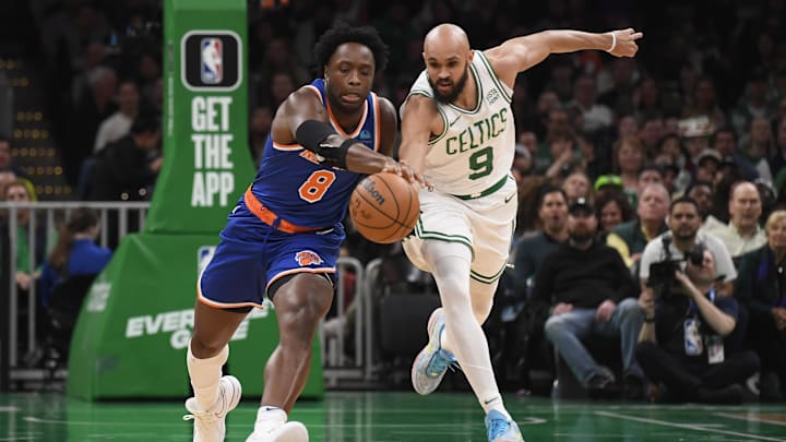 Apr 11, 2024; Boston, Massachusetts, USA;  Boston Celtics guard Derrick White (9) tries to steal the ball from New York Knicks forward OG Anunoby (8) during the first half at TD Garden. Mandatory Credit: Bob DeChiara-Imagn Images