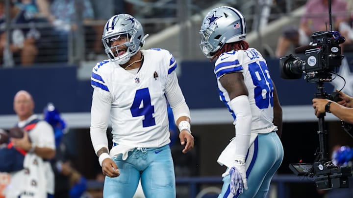 Dallas Cowboys quarterback Dak Prescott celebrates with wide receiver CeeDee Lamb after a touchdown pass during the first quarter against the New England Patriots in an October 2023 game.