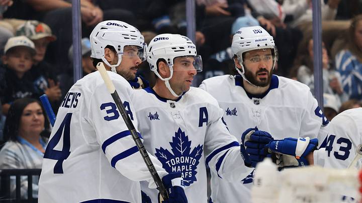 Oct 13, 2026; Salt Lake City, Utah, USA;  Toronto Maple Leafs center John Tavares (middle) celebrates with center Auston Matthews (34) and right wing Kirill Marchenko (86) after scoring a goal against the Utah Mammoth during the third period at Delta Center.  Mandatory Credit: Rob Gray-Imagn Images