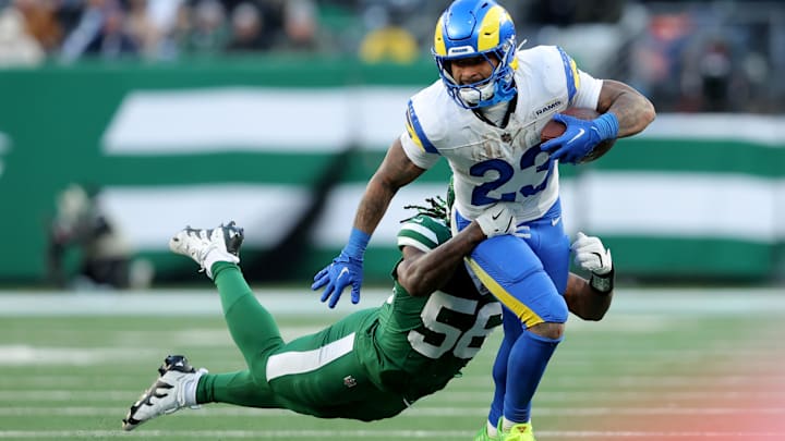 Dec 22, 2024; East Rutherford, New Jersey, USA; Los Angeles Rams running back Kyren Williams (23) runs with the ball against New York Jets linebacker Quincy Williams (56) during the fourth quarter at MetLife Stadium. Mandatory Credit: Brad Penner-Imagn Images