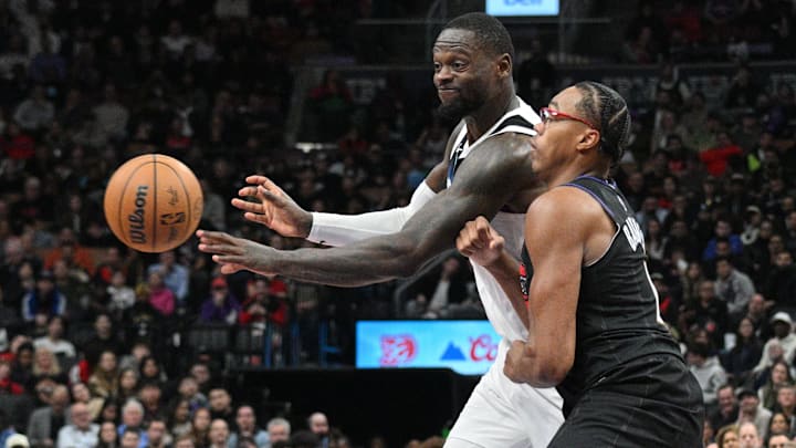 Nov 21, 2024; Toronto, Ontario, CAN;  Minnesota Timberwolves forward Julius Randle (30) passes the ball away from Toronto Raptors forward Scottie Barnes (4) in the second half at Scotiabank Arena.