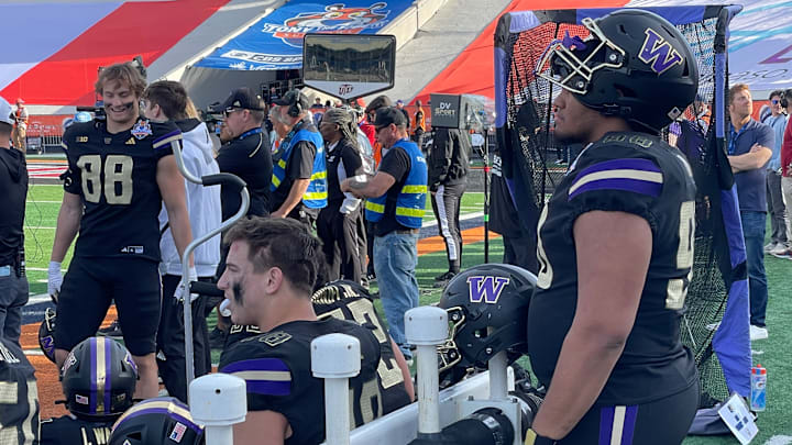 Omar Khan watches the Sun Bowl from the Husky sideline. 