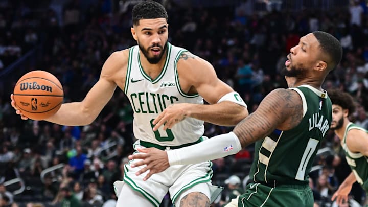 Boston Celtics forward Jayson Tatum (0) drives for the basket against Milwaukee Bucks guard Damian Lillard (0) in the third quarter at Fiserv Forum.