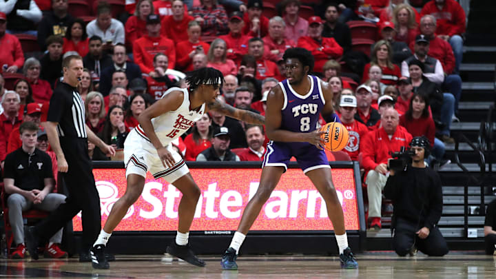 Jan 29, 2025; Lubbock, Texas, USA; Texas Christian Horned Frogs center Ernest Udeh Jr (8) looks to pass the ball against Texas Tech Red Raiders forward JT Toppin (15) in the first half at United Supermarkets Arena. Mandatory Credit: Michael C. Johnson-Imagn Images Jan 29, 2025; Lubbock, Texas, USA; Texas Christian Horned Frogs center Ernest Udeh Jr (8) looks to pass the ball against Texas Tech Red Raiders forward JT Toppin (15) in the first half at United Supermarkets Arena. Mandatory Credit: Michael C. Johnson-Imagn Images