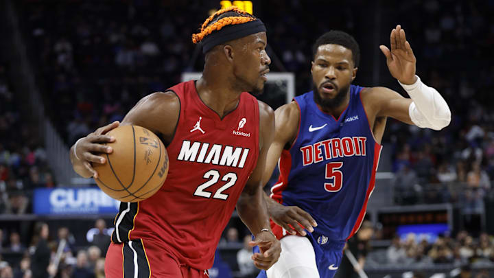 Dec 16, 2024; Detroit, Michigan, USA;  Miami Heat forward Jimmy Butler (22) dribbles as Detroit Pistons guard Malik Beasley (5) defends in the first half at Little Caesars Arena. Mandatory Credit: Rick Osentoski-Imagn Images