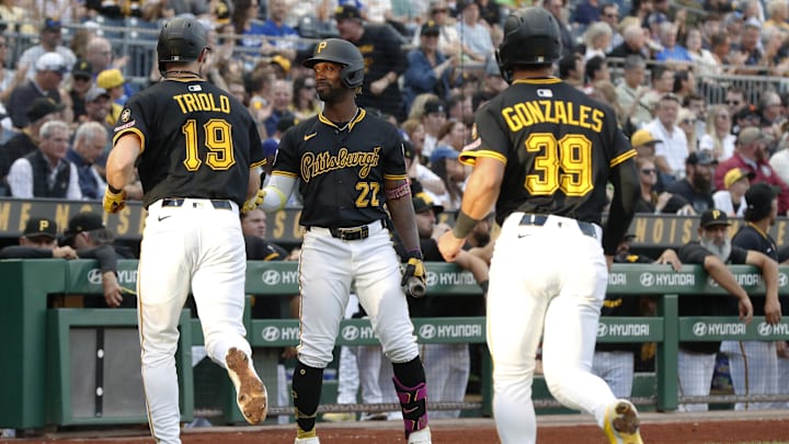 Sep 2, 2025; Pittsburgh, Pennsylvania, USA; Pittsburgh Pirates designated hitter Andrew McCutchen (22) congratulates shortstop Jared Triolo (19) and second baseman Nick Gonzales (39) after both players scored runs  against the Los Angeles Dodgers during the first inning at PNC Park. Mandatory Credit: Charles LeClaire-Imagn Images
