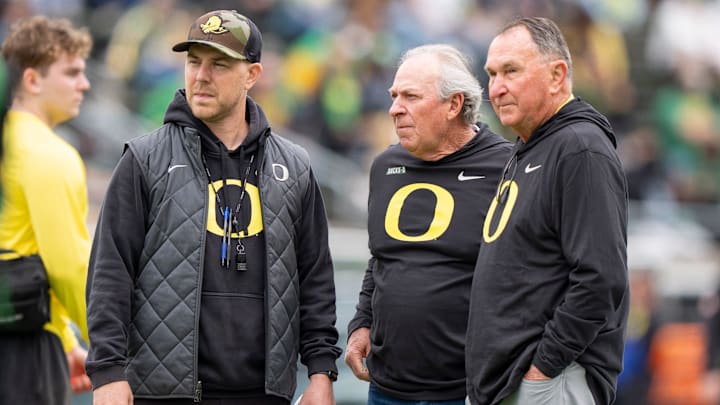 Oregon offensive coordinator Will Stein, left, former Oregon defensive coordinator Nick Aliotti and former Oregon coach Rich Brooks talk before the game as the Fighting Ducks face off against Mighty Oregon in the Oregon Ducks spring game on April 26, 2025, at Autzen Stadium in Eugene.