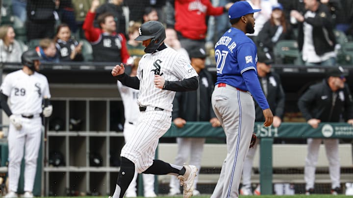 Apr 4, 2026; Chicago, Illinois, USA; Chicago White Sox left fielder Austin Hays (21) scores against the Toronto Blue Jays during the eight inning at Rate Field. Mandatory Credit: Kamil Krzaczynski-Imagn Images