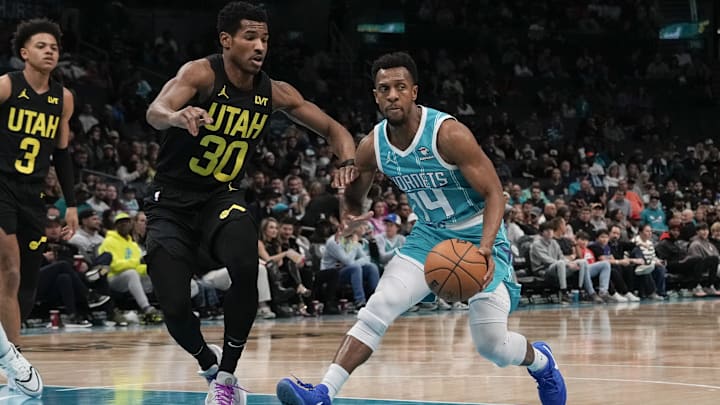Jan 27, 2024; Charlotte, North Carolina, USA; Charlotte Hornets guard Ish Smith (14) handles the ball defended by Utah Jazz guard Ochai Agbaji (30) during the second quarter at Spectrum Center. Mandatory Credit: Jim Dedmon-Imagn Images Jan 27, 2024; Charlotte, North Carolina, USA; Charlotte Hornets guard Ish Smith (14) handles the ball defended by Utah Jazz guard Ochai Agbaji (30) during the second quarter at Spectrum Center. Mandatory Credit: Jim Dedmon-Imagn Images