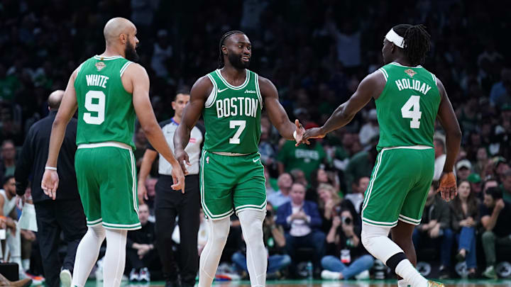 Oct 22, 2024; Boston, Massachusetts, USA; Boston Celtics guard Jaylen Brown (7), guard Jrue Holiday (4) and guard Derrick White (9) react after a play against the New York Knicks in the second half at TD Garden. Mandatory Credit: David Butler II-Imagn Images