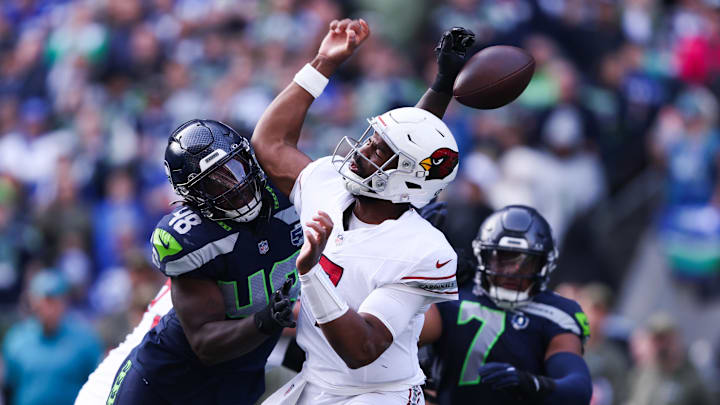 Nov 9, 2025; Seattle, Washington, USA; Arizona Cardinals quarterback Jacoby Brissett (7) fumbles the ball as Seattle Seahawks linebacker Tyrice Knight (48) defends during the second quarter at Lumen Field. Mandatory Credit: Kevin Ng-Imagn Images