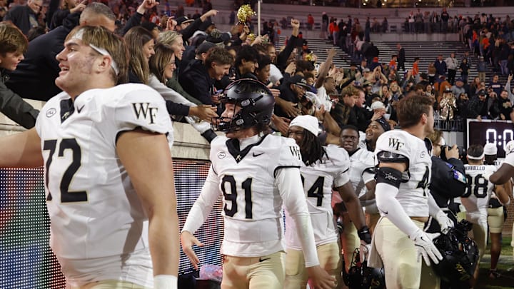 Nov 8, 2025; Charlottesville, Virginia, USA; Wake Forest Demon Deacons punter Cal Joseph (91) celebrates with fans in the stands after defeating the Virginia Cavaliers at Scott Stadium. Mandatory Credit: Amber Searls-Imagn Images