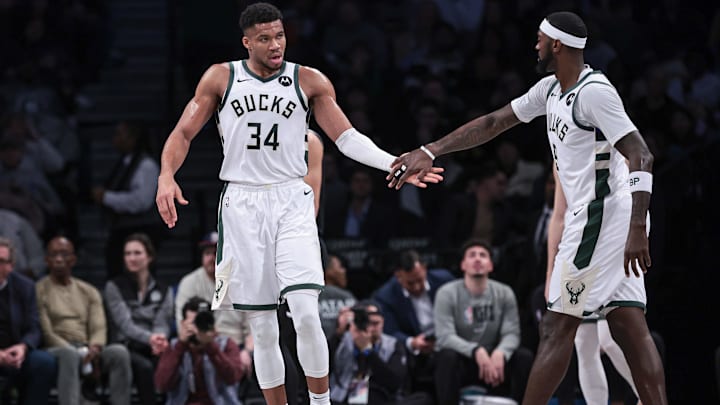 Dec 27, 2023; Brooklyn, New York, USA; Milwaukee Bucks forward Giannis Antetokounmpo (34) slaps hands with forward Bobby Portis (9) during the first half against the Brooklyn Nets at Barclays Center. Mandatory Credit: Vincent Carchietta-Imagn Images