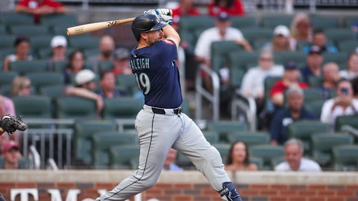 Sep 5, 2025; Atlanta, Georgia, USA; Seattle Mariners catcher Cal Raleigh (29) hits a single against the Atlanta Braves in the first inning at Truist Park. Mandatory Credit: Brett Davis-Imagn Images