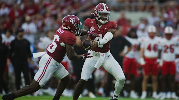 Aug 31, 2024; Tuscaloosa, Alabama, USA; Alabama Crimson Tide quarterback Jalen Milroe (4) passes off the ball to Jam Miller (26) during the first quarter at Bryant-Denny Stadium. Mandatory Credit: Will McLelland-Imagn Images