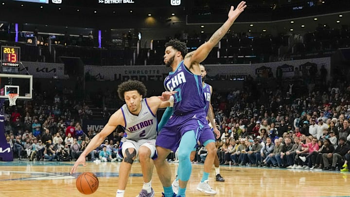 Feb 27, 2022; Charlotte, North Carolina, USA; Detroit Pistons guard Cade Cunningham (2) tries to get past Charlotte Hornets forward Miles Bridges (0) during the second half at the Spectrum Center. Mandatory Credit: Jim Dedmon-Imagn Imagesthe