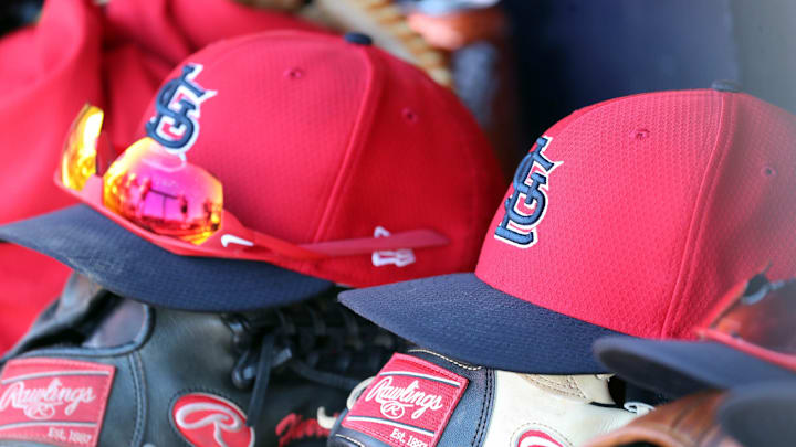 Mar 6, 2019; Tampa, FL, USA; St. Louis Cardinals hat and gloves lay in the dugout at George M. Steinbrenner Field. Mandatory Credit: Kim Klement-Imagn Images