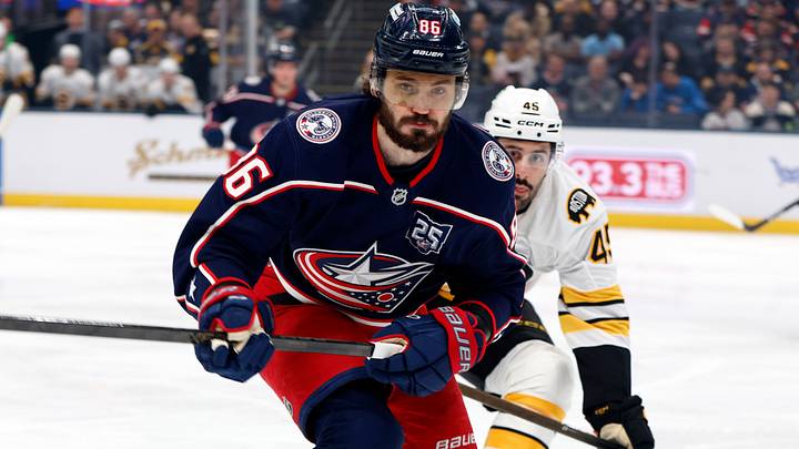 Apr 12, 2026; Columbus, Ohio, USA; Columbus Blue Jackets right wing Kirill Marchenko (86) and Boston Bruins defenseman Jonathan Aspirot (45) skate after a loose puck during the first period at Nationwide Arena. Mandatory Credit: Russell LaBounty-Imagn Images
