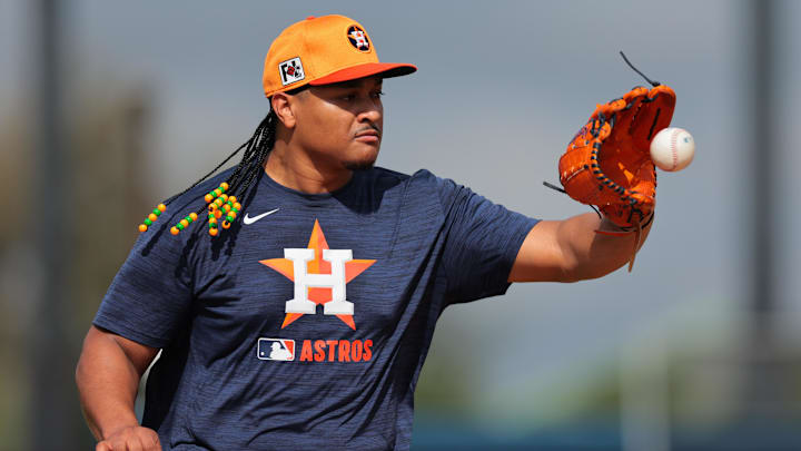 Feb 14, 2025; West Palm Beach, FL, USA; Houston Astros starting pitcher Luis Garcia (77) works on a fielding exercise during a spring training workout at CACTI Park of the Palm Beaches.`