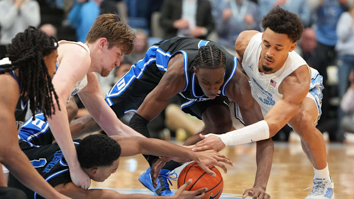 Feb 7, 2026; Chapel Hill, North Carolina, USA; Duke Blue Devils forward Maliq Brown (6) and guards Caleb Foster (1) and Dame Sarr (7) and North Carolina Tar Heels center Henri Veesaar (13) and guard Seth Trimble (7) fight for the ball in the second half at Dean E. Smith Center. Mandatory Credit: Bob Donnan-Imagn Images Feb 7, 2026; Chapel Hill, North Carolina, USA; Duke Blue Devils forward Maliq Brown (6) and guards Caleb Foster (1) and Dame Sarr (7) and North Carolina Tar Heels center Henri Veesaar (13) and guard Seth Trimble (7) fight for the ball in the second half at Dean E. Smith Center. Mandatory Credit: Bob Donnan-Imagn Images