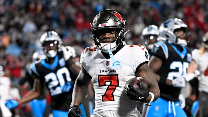 Dec 1, 2024; Charlotte, North Carolina, USA;  Tampa Bay Buccaneers running back Bucky Irving (7) scores a touchdown in the fourth quarter at Bank of America Stadium. Mandatory Credit: Bob Donnan-Imagn Images
