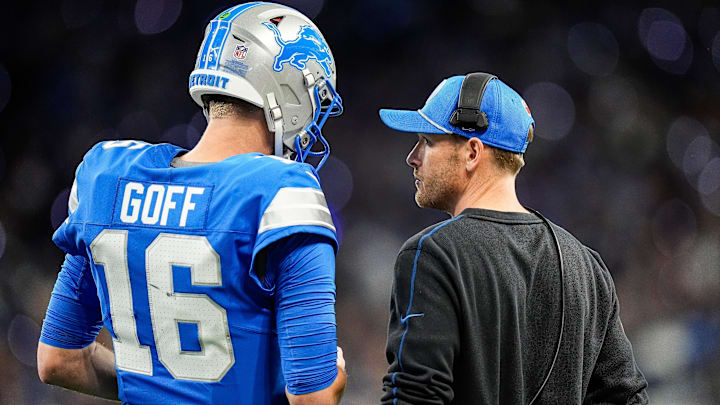 Detroit Lions quarterback Jared Goff (16), left, talks to offensive coordinator Ben Johnson 