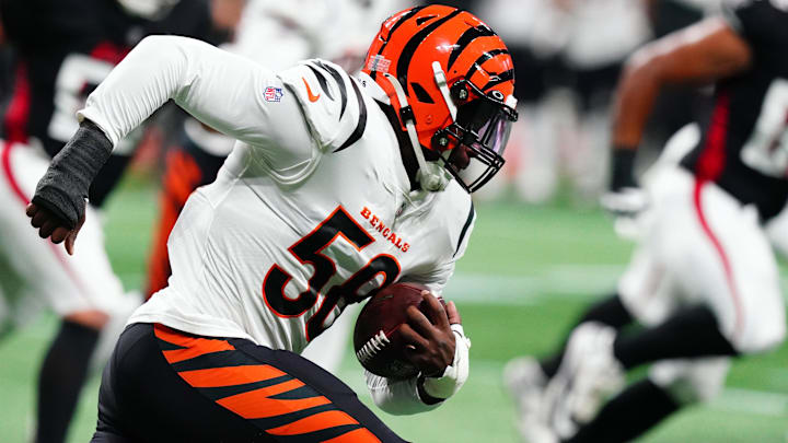 Aug 18, 2023; Atlanta, Georgia, USA; Cincinnati Bengals defensive end Joseph Ossai (58) returns an interception off Atlanta Falcons quarterback Desmond Ridder (9)  during the first quarter at Mercedes-Benz Stadium. Mandatory Credit: John David Mercer-Imagn Images