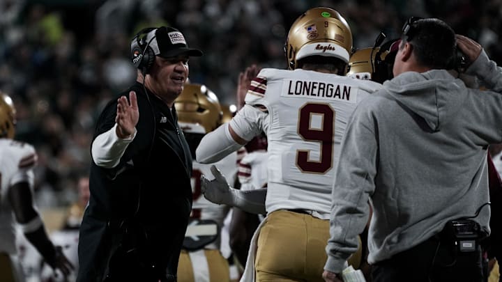 Sep 6, 2025; East Lansing, Michigan, USA; Boston College head coach Bill O'Brien celebrates with Boston College quarterback Dylan Lonergan (9) after a scoring drive in the second quarter at Spartan Stadium. Mandatory Credit: Brendan Mullin-Imagn Images Sep 6, 2025; East Lansing, Michigan, USA; Boston College head coach Bill O'Brien celebrates with Boston College quarterback Dylan Lonergan (9) after a scoring drive in the second quarter at Spartan Stadium. Mandatory Credit: Brendan Mullin-Imagn Images