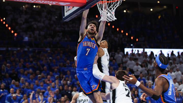 May 20, 2026; Oklahoma City, Oklahoma, USA; Oklahoma City Thunder center Chet Holmgren (7) dunks as San Antonio Spurs center Luke Kornet (7) defends during the third quarter during game two of the western conference finals for the 2026 NBA playoffs at Paycom Center. Mandatory Credit: Brett Rojo-Imagn Images