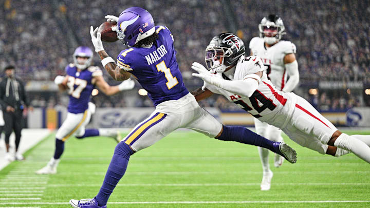 Sep 14, 2025; Minneapolis, Minnesota, USA; Minnesota Vikings wide receiver Jalen Nailor (1) runs for a touchdown as Atlanta Falcons cornerback A.J. Terrell Jr. (24) defends during the first half at U.S. Bank Stadium. Mandatory Credit: Jeffrey Becker-Imagn Images