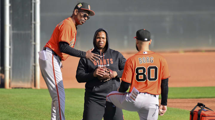 San Francisco Giants infielder Rafeal Devers (16) works out with third base coach Hector Borg (80) and infield coach Ron Washington (37).