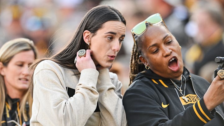 Oct 26, 2024; Iowa City, Iowa, USA; Former Iowa Hawkeye and current Indiana Fever WNBA star Caitlin Clark (left) reacts with friends and family while being honored during the game between the Iowa Hawkeyes and the Northwestern Wildcats at Kinnick Stadium. Mandatory Credit: Jeffrey Becker-Imagn Images Oct 26, 2024; Iowa City, Iowa, USA; Former Iowa Hawkeye and current Indiana Fever WNBA star Caitlin Clark (left) reacts with friends and family while being honored during the game between the Iowa Hawkeyes and the Northwestern Wildcats at Kinnick Stadium. Mandatory Credit: Jeffrey Becker-Imagn Images