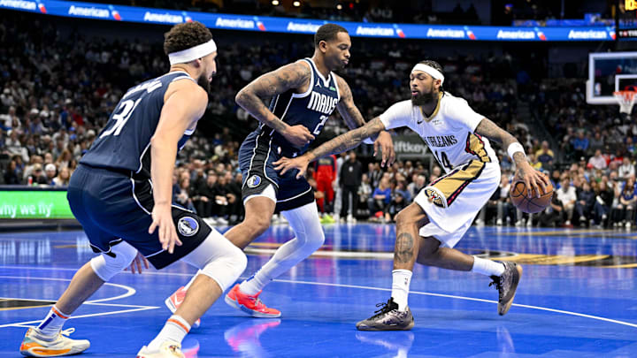 Nov 19, 2024; Dallas, Texas, USA; New Orleans Pelicans forward Brandon Ingram (14) looks to move the ball past Dallas Mavericks forward P.J. Washington (25) and guard Klay Thompson (31) during the first quarter at the American Airlines Center. Mandatory Credit: Jerome Miron-Imagn Images