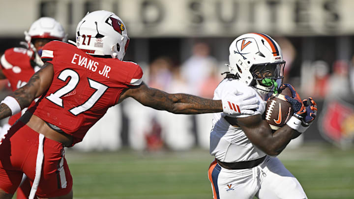Virginia's back J'Mari Taylor, right, runs the ball against Louisville Virginia's back J'Mari Taylor, right, runs the ball against Louisville