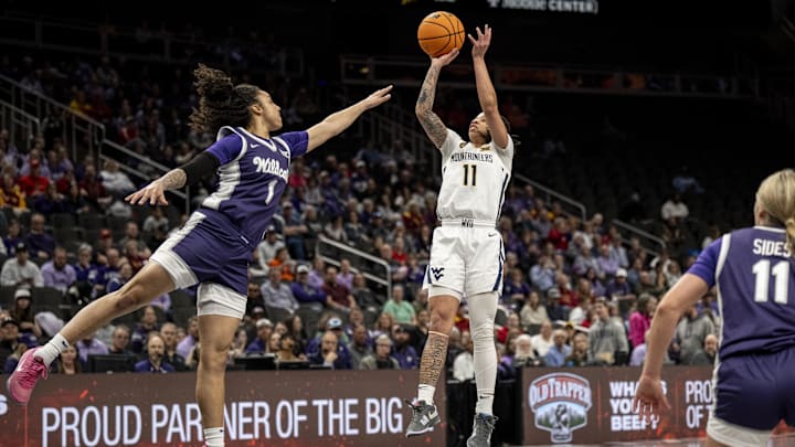 Mar 7, 2025; Kansas City, MO, USA; West Virginia Mountaineers JJ Quinerly (11) shoots the ball while defended by Kansas State Wildcats guard Zyanna Walker (1) in the first quarter at T-Mobile Center. Mandatory Credit: Amy Kontras-Imagn Images